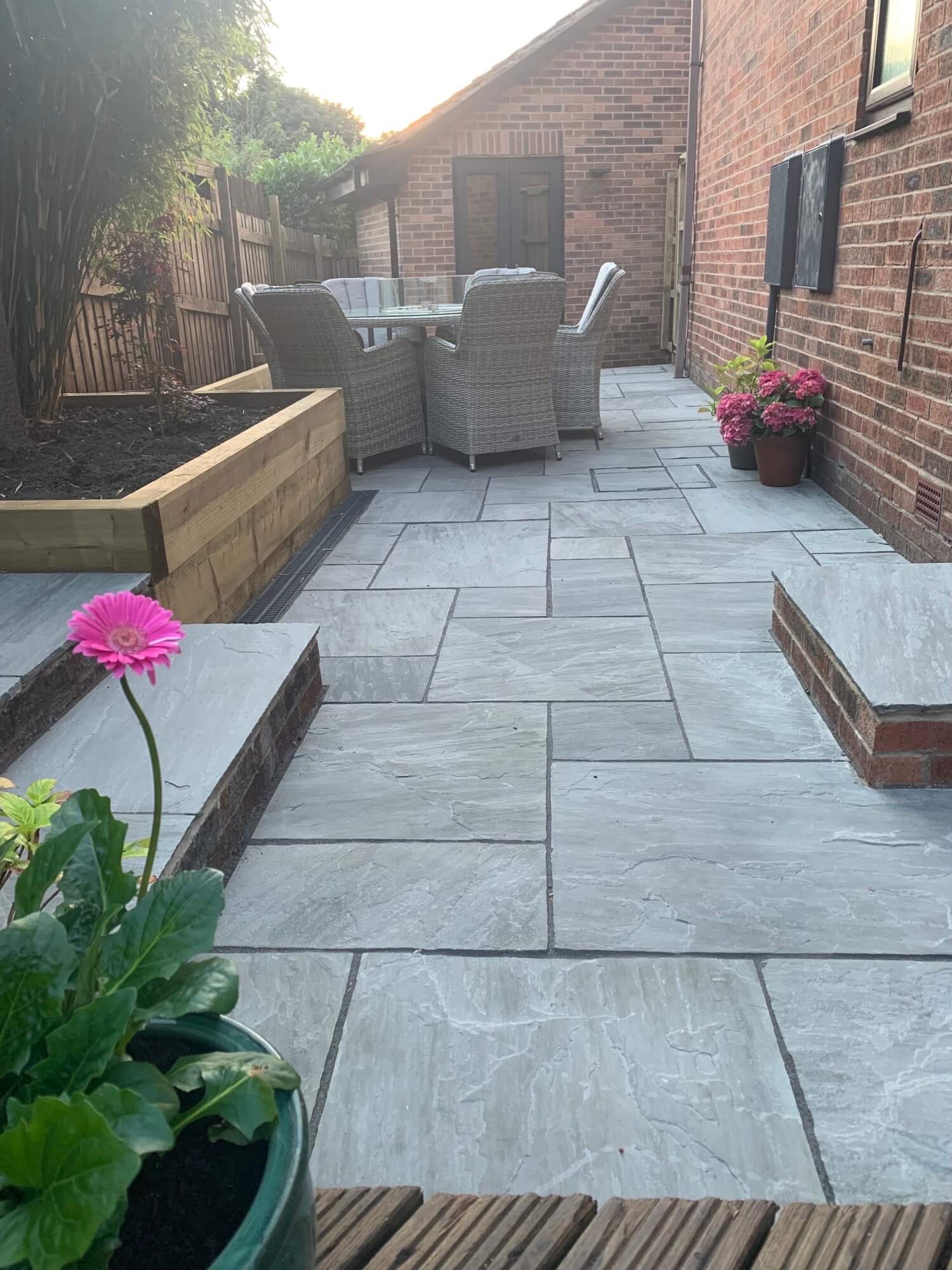 Indian sandstone patio with lawn