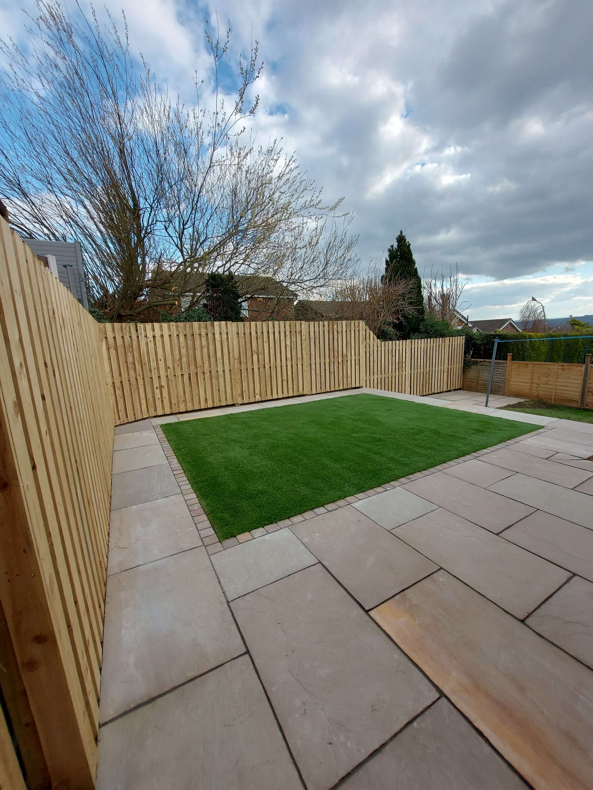 Large paved patio and lawn in a Yorkshire garden